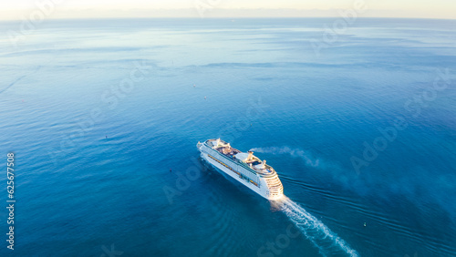 Obraz na płótnie Cruise ship sailing across The Mediterranean sea - Aerial footage. Miami. USA. Aerial view of beautiful white cruise ship above luxury cruise in the ocean sea concept tourism travel on holiday. w salonie