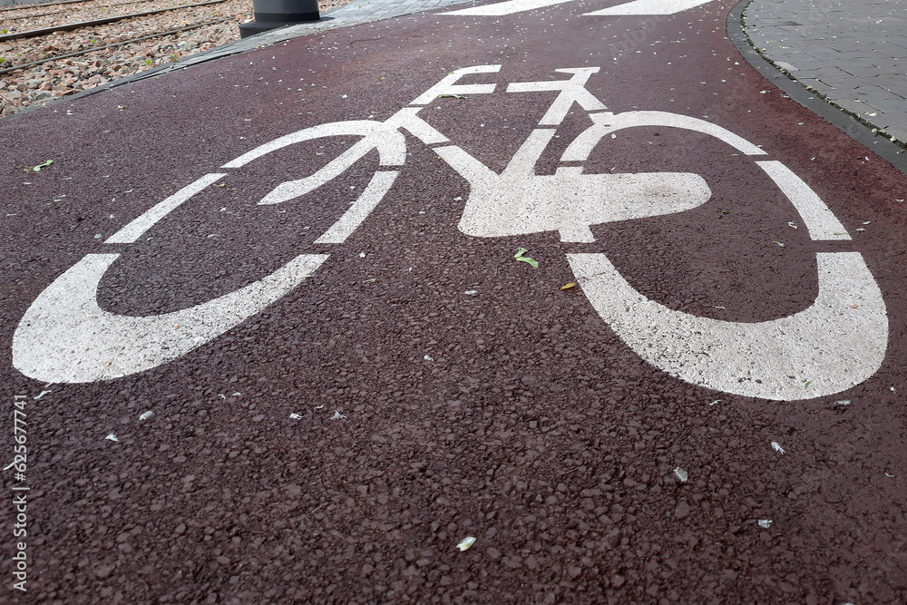 Fototapeta premium Road markings marking road for cyclists. Walkway for riding scooters. Image of bike on pavement. Traffic Laws. Concept of cycling with family and friends. Highway code.