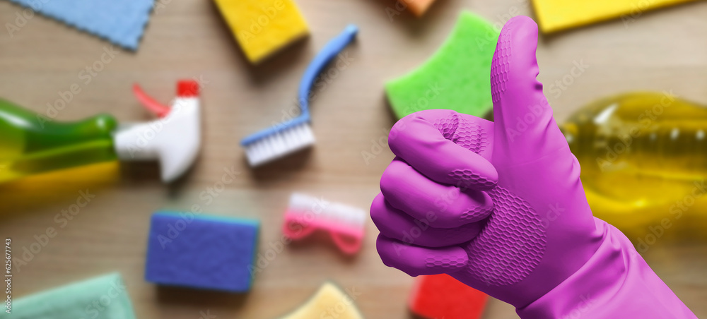 Naklejka premium Banner with thumbs up in pink rubber glove. Gloved hand shows the Like symbol on background of household goods. Header for website, blog, advert, flyer, article. Hardware store and cleaning service.