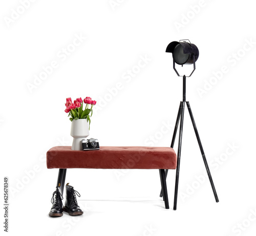 Vase with tulips, photo camera, pink bench, lamp and shoes on white background