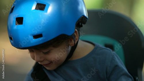 One happy little boy wearing bicycle helmet portrait face clapping hands