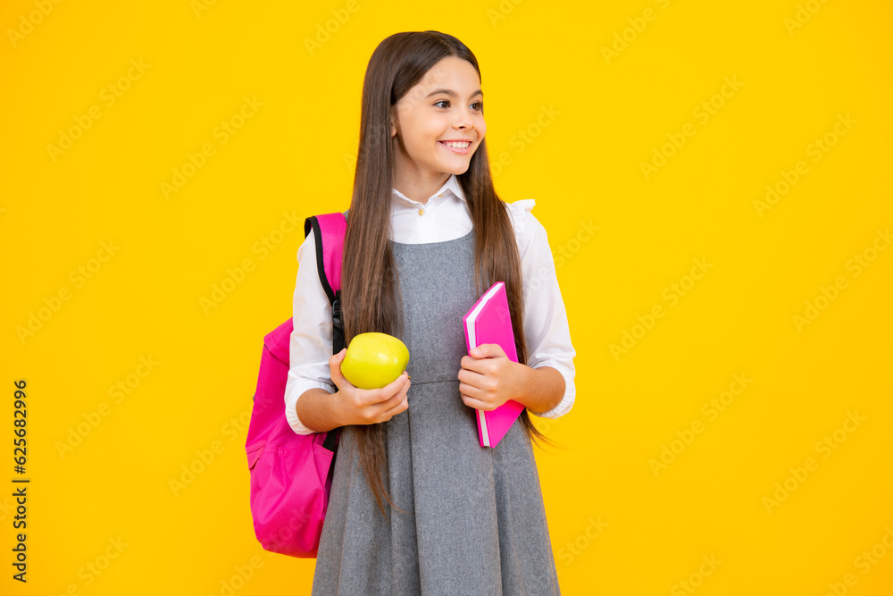 Schoolchild, teenage student girl hold book on yellow isolated studio background. School and education concept. Back to school. Schoolchild, teenage student girl hold book on yellow isolated studio background. School and education concept. Back to school.