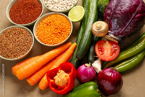 Different fresh vegetables and cereals on brown background  closeup