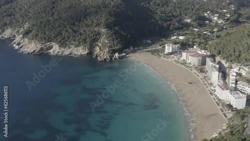 A mesmerizing view of San Vicente cove in Ibiza, with crystal clear blue sea and beautiful sandy beach