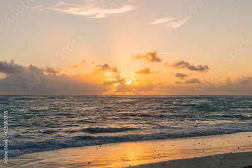 lever de soleil derri  re les nuages au dessus de l oc  an tel que vu    partir de la plage