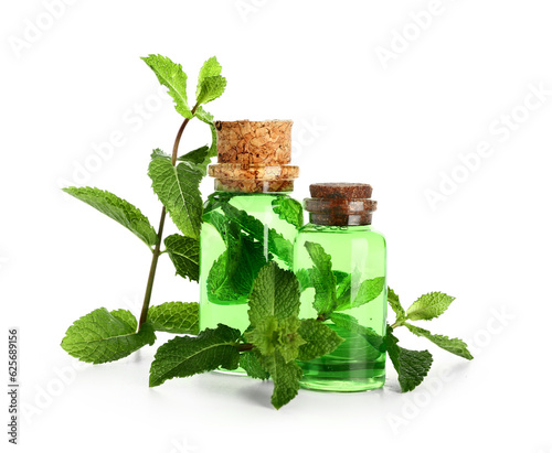 Bottles of essential oil and fresh mint isolated on white background