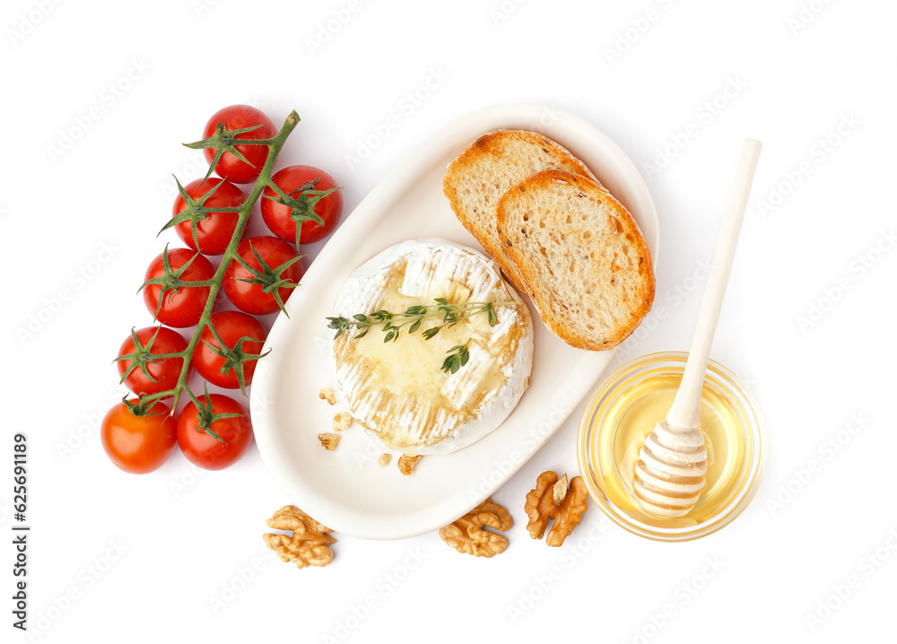 Plate of tasty baked Camembert cheese with tomatoes, honey and bread on white background Plate of tasty baked Camembert cheese with tomatoes, honey and bread on white background