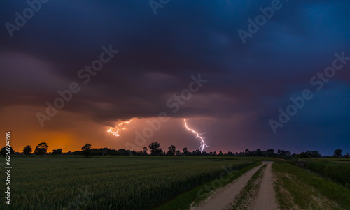 Storm over glade road in the middle of the fields. Stegna, Zulawy, Pomerania, Poland.