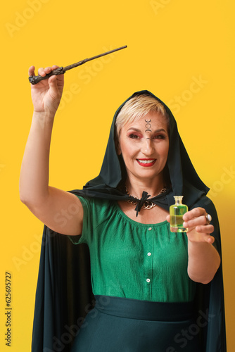 Mature witch with magic wan...