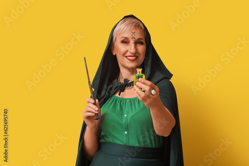 Mature witch with magic wan...
