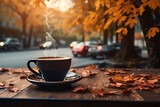 cup of coffee on cafe table street view with cars and fall autumn leaves