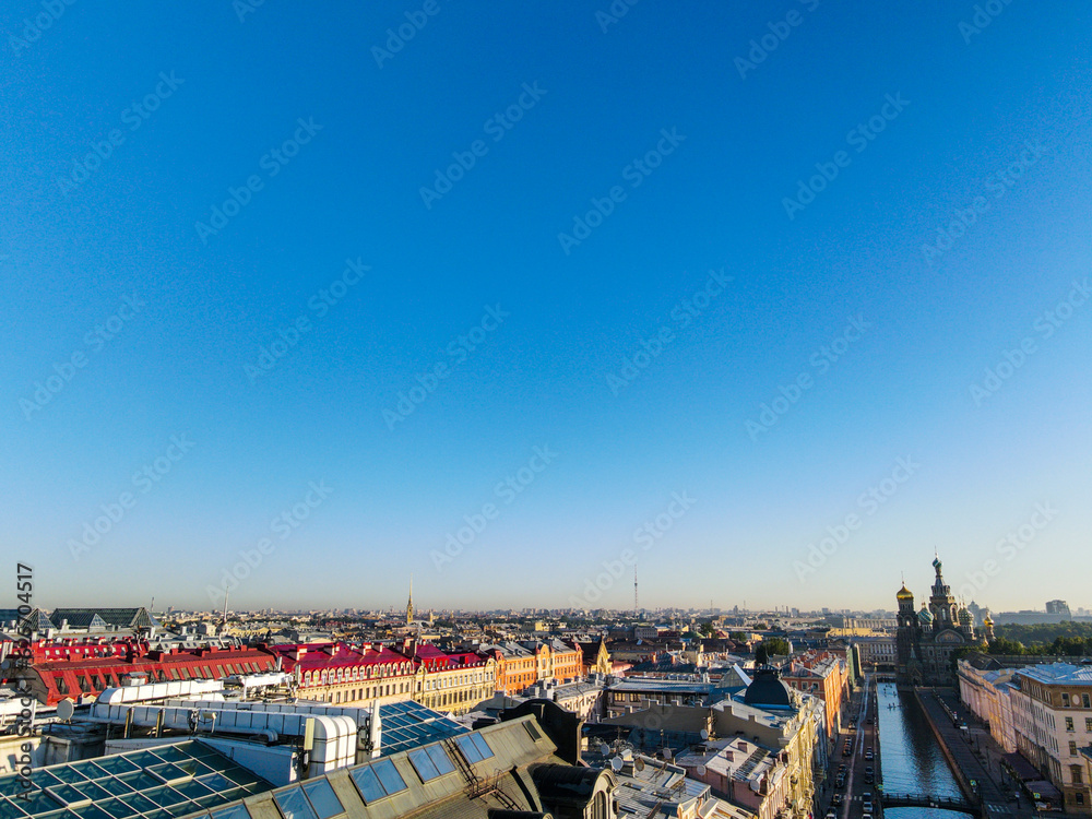 Obraz premium Aerial up view of the Nevski street and Cathedral of the Resurrection of Christ next to House of the Singer company in the historical city of St.Petersburg at sunny summer sunrise