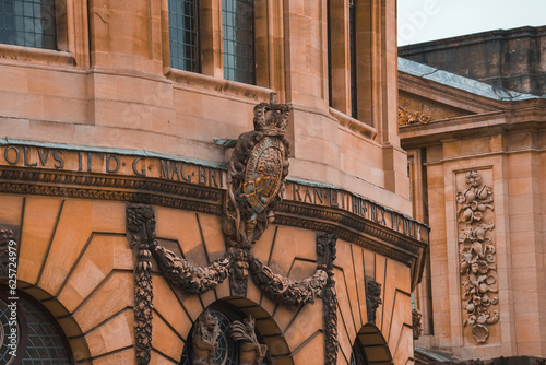 Inscription about Charles II with stone work details over The Sheldonian Theatre, Oxford, United Kingdom. photo
