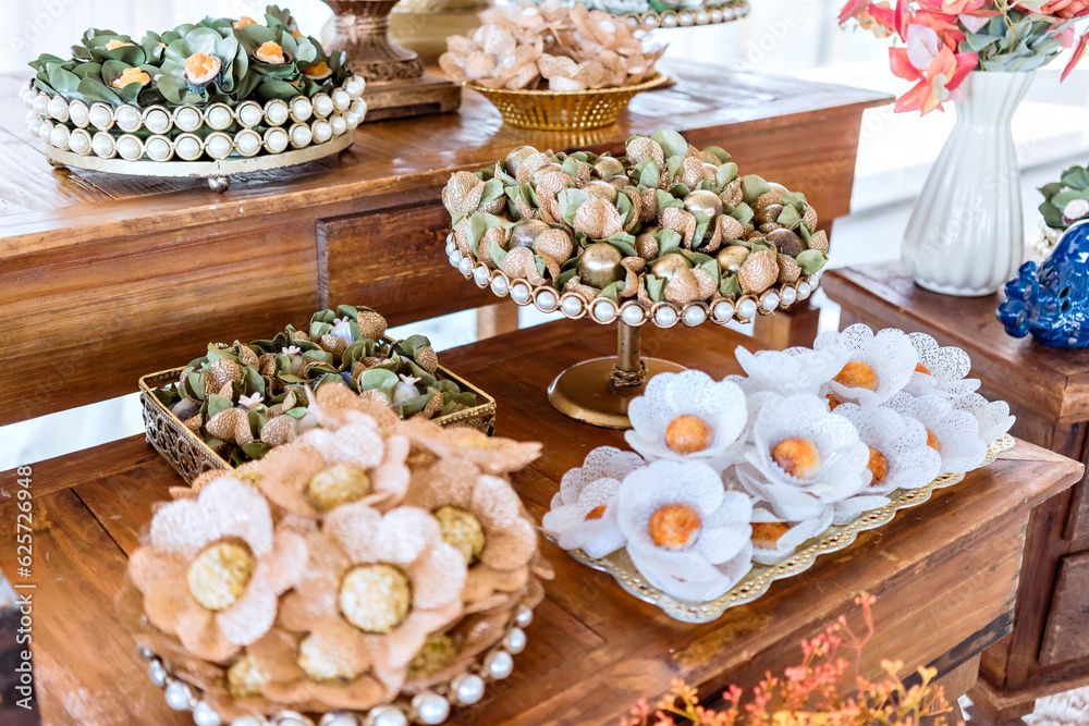 trays with party brigadeiros on top of a wooden table trays with party brigadeiros on top of a wooden table