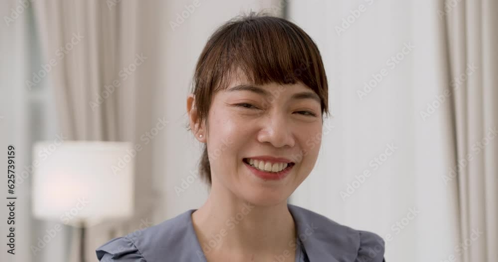 Closeup face portrait of happy young pretty Asian female nurse having relaxation, expression confident, smiling and laughing at the camera. The charming lady woman standing in living room. Closeup face portrait of happy young pretty Asian female nurse having relaxation, expression confident, smiling and laughing at the camera. The charming lady woman standing in living room.