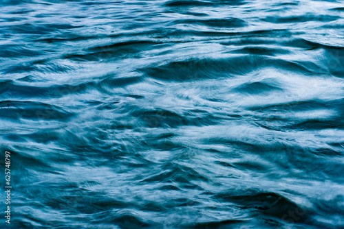 macro blue wave pattern in a river with motion blur photo