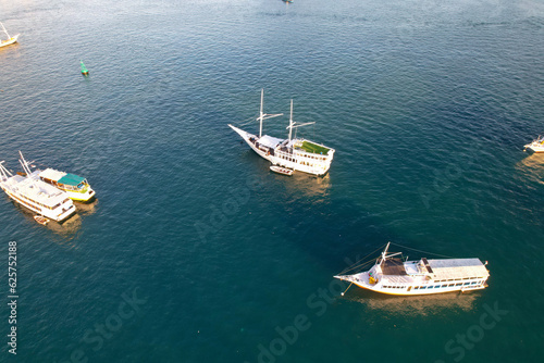 Labuan Bajo port - Rush Hour view in Labuan Bajo Harbour in the morning with Luxury Phinisi view Sailing Komodo National Park  © Ara Creative