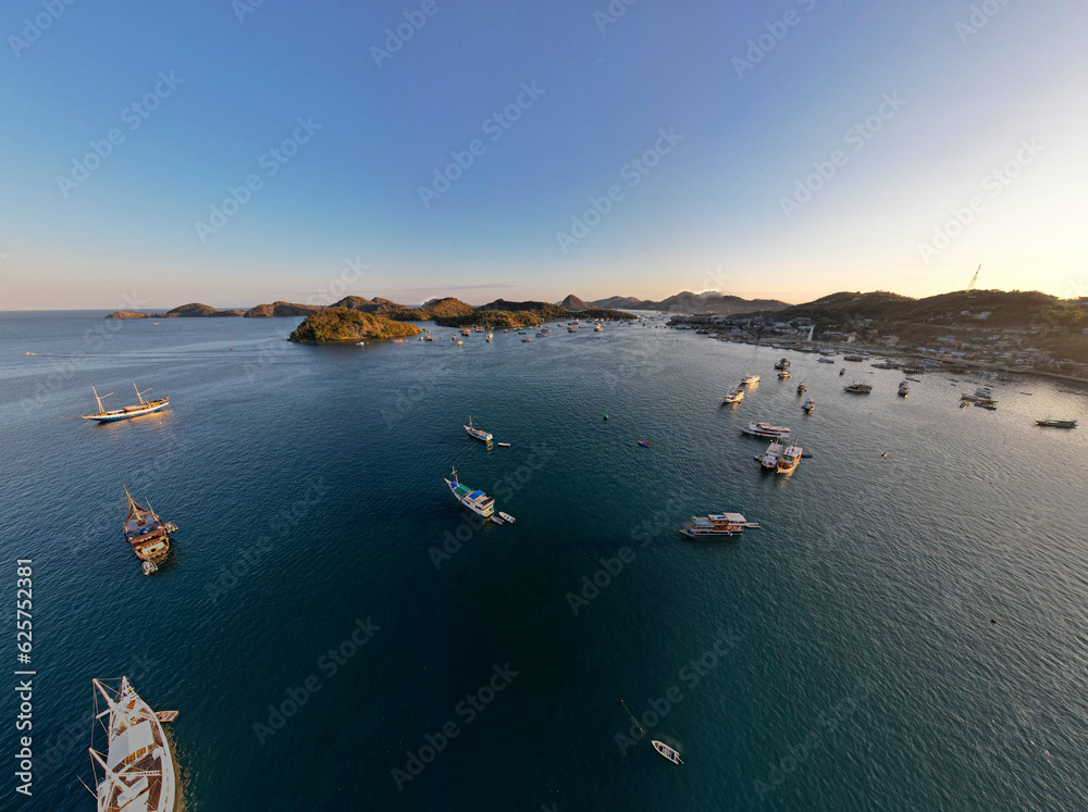 Labuan Bajo port - Rush Hour view in Labuan Bajo Harbour in the morning with Luxury Phinisi view Sailing Komodo National Park Labuan Bajo port - Rush Hour view in Labuan Bajo Harbour in the morning with Luxury Phinisi view Sailing Komodo National Park
