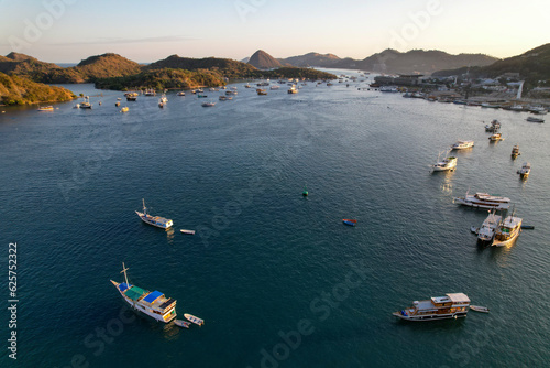 Labuan Bajo port - Rush Hour view in Labuan Bajo Harbour in the morning with Luxury Phinisi view Sailing Komodo National Park  © Ara Creative