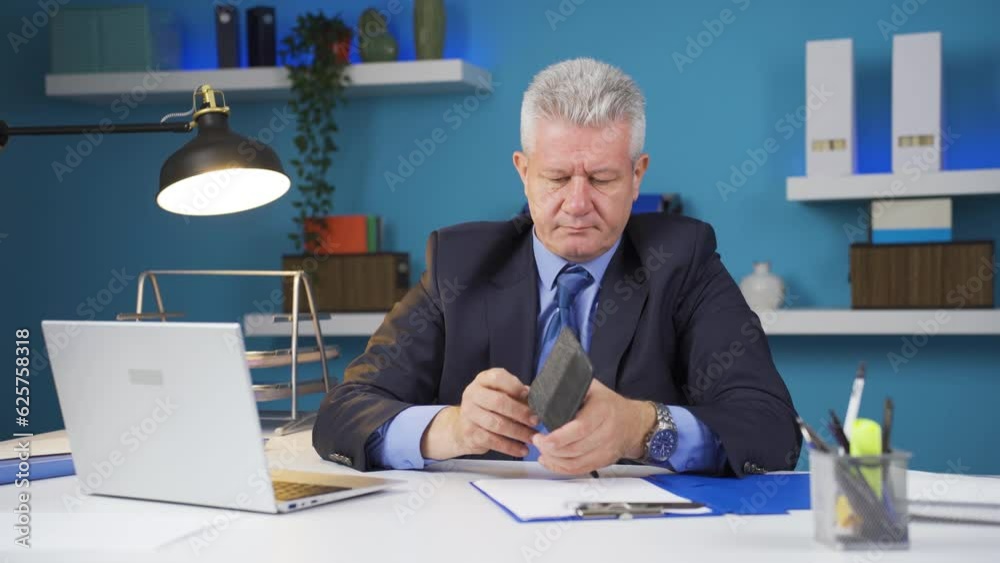 Businessman showing his empty wallet to the camera. Businessman showing his empty wallet to the camera.