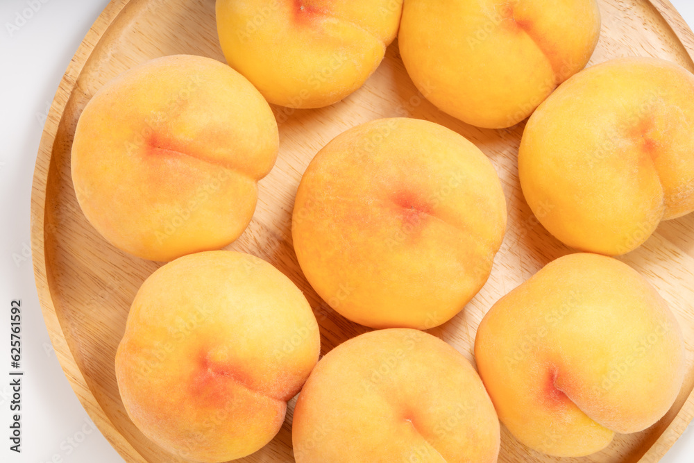 Yellow Peach with sliced on white Background, Fresh peach in wooden basket on white Background. Yellow Peach with sliced on white Background, Fresh peach in wooden basket on white Background.