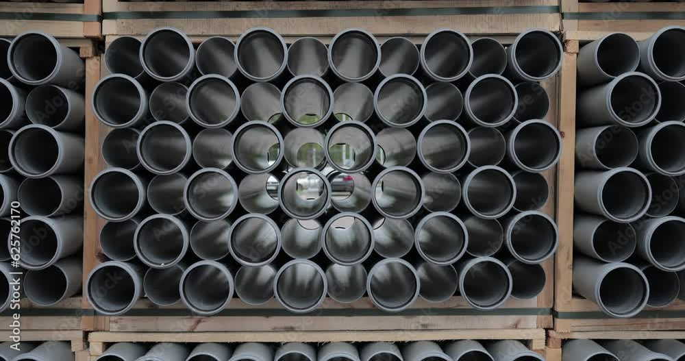 a large warehouse of a new gray plastic sewer pipe in the open air in the original movement a large warehouse of a new gray plastic sewer pipe in the open air in the original movement