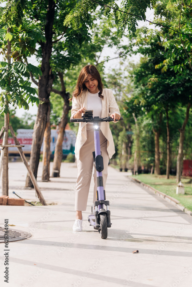 asian woman riding electric scooter in the park, lifestyle concept