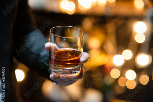 Businessman sitting and holding glass of whiskey