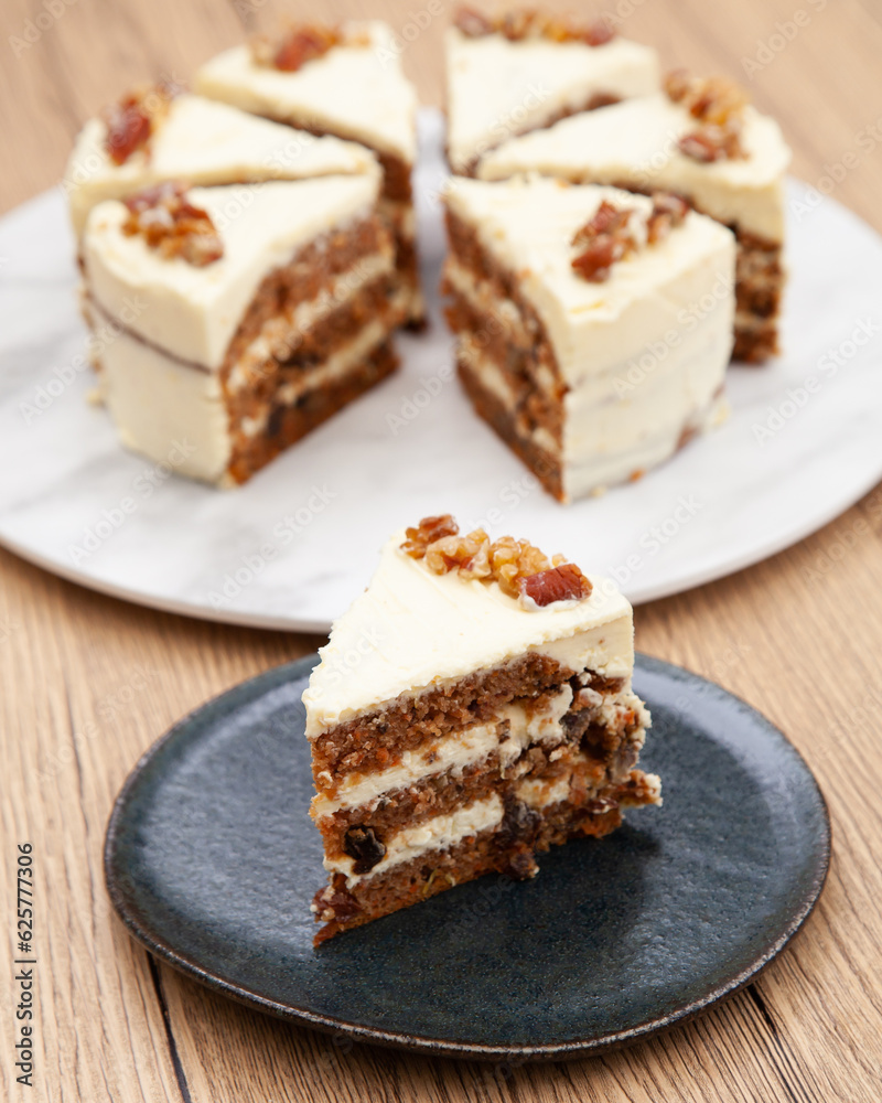 Classic carrot cake with cream cheese frosting, pecan, walnut and raisin Classic carrot cake with cream cheese frosting, pecan, walnut and raisin