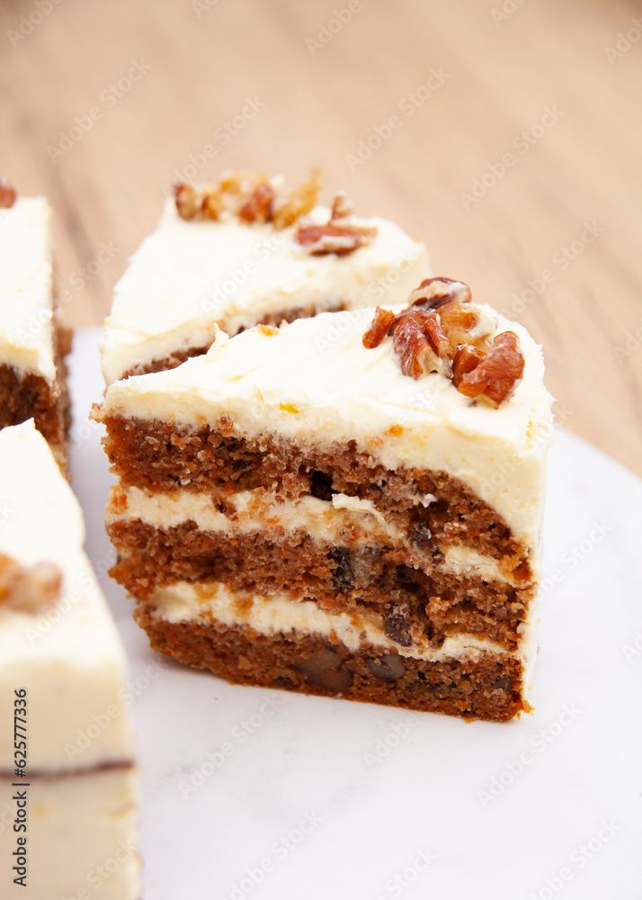 Classic carrot cake with cream cheese frosting, pecan, walnut and raisin Classic carrot cake with cream cheese frosting, pecan, walnut and raisin