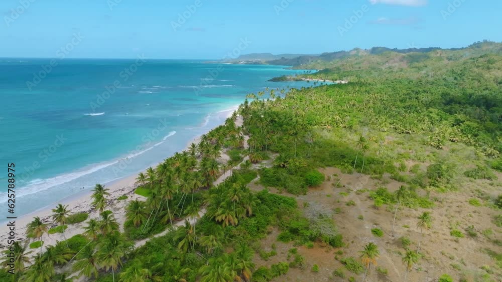 Drone panorama view showing green island with sandy beach and Caribbean sea during sunlight - tropical landscape flight over Dominican Republic island Drone panorama view showing green island with sandy beach and Caribbean sea during sunlight - tropical landscape flight over Dominican Republic island
