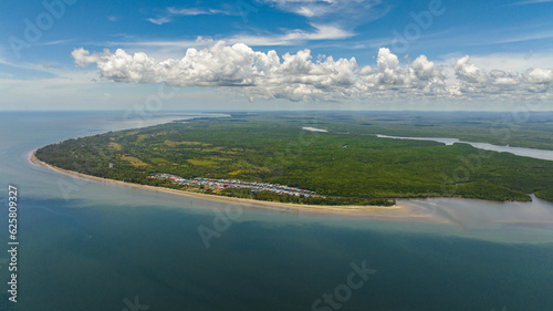 Aerial view of from the sea on the coast of the island of Borneo with tropical vegetation. Sabah, Malaysia.