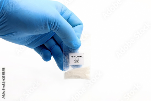 Blue glove holding a pouch of fentanyl, a potent opioid that causes overdose deaths