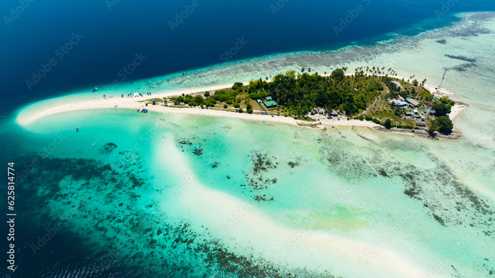 A beautiful Sibuan island with a beach and a coral atoll. Tun Sakaran Marine Park. Borneo, Sabah, Malaysia.
