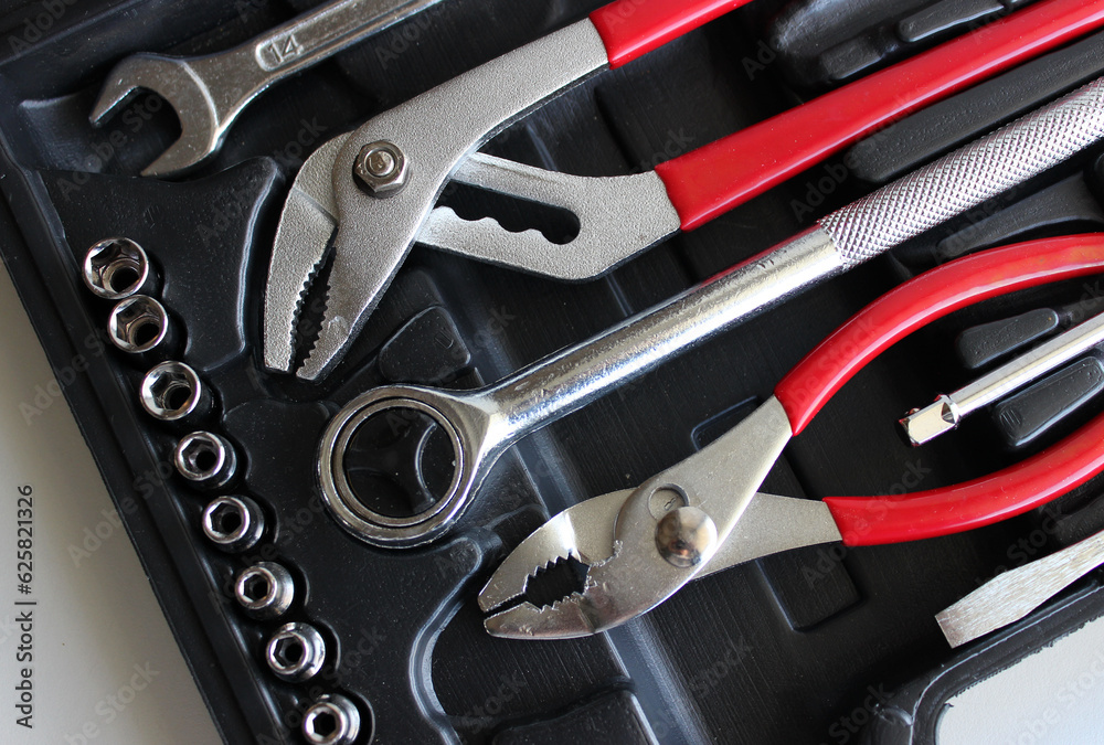 Fototapeta premium Opened case with chrome hand tools and equipment for mechanical works closeup stock photo 