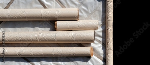 Photo of rolls of toilet paper on a white sheet with empty space for text or design with copy space