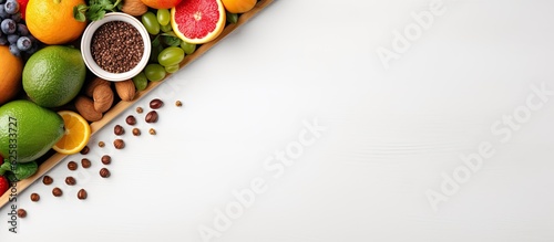 Photo of a vibrant arrangement of fruits and vegetables forming a colorful triangle with copy space