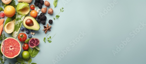 Photo of a colorful assortment of fruits and vegetables on a vibrant blue background with plenty of room for text or design elements with copy space