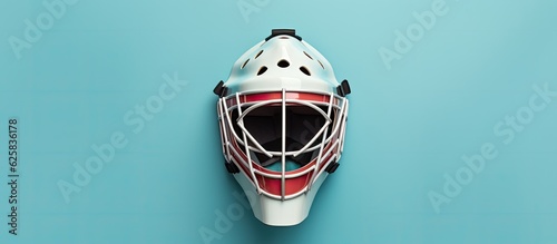 Photo of a goalie mask on a vibrant blue background with copy space