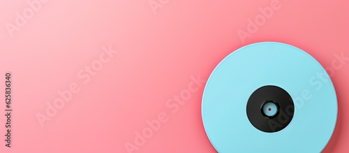 Photo of a blue and black object on a pink background with plenty of copy space with copy space