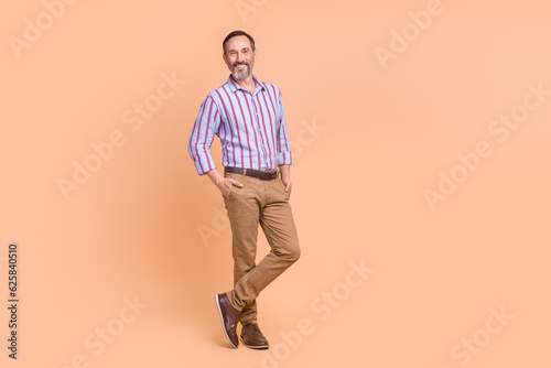 Portrait of friendly person with white gray beard dressed colorful shirt arms in pockets at office isolated on pastel color background