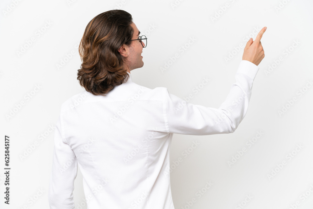 Business handsome man isolated on white background pointing back with the index finger Business handsome man isolated on white background pointing back with the index finger