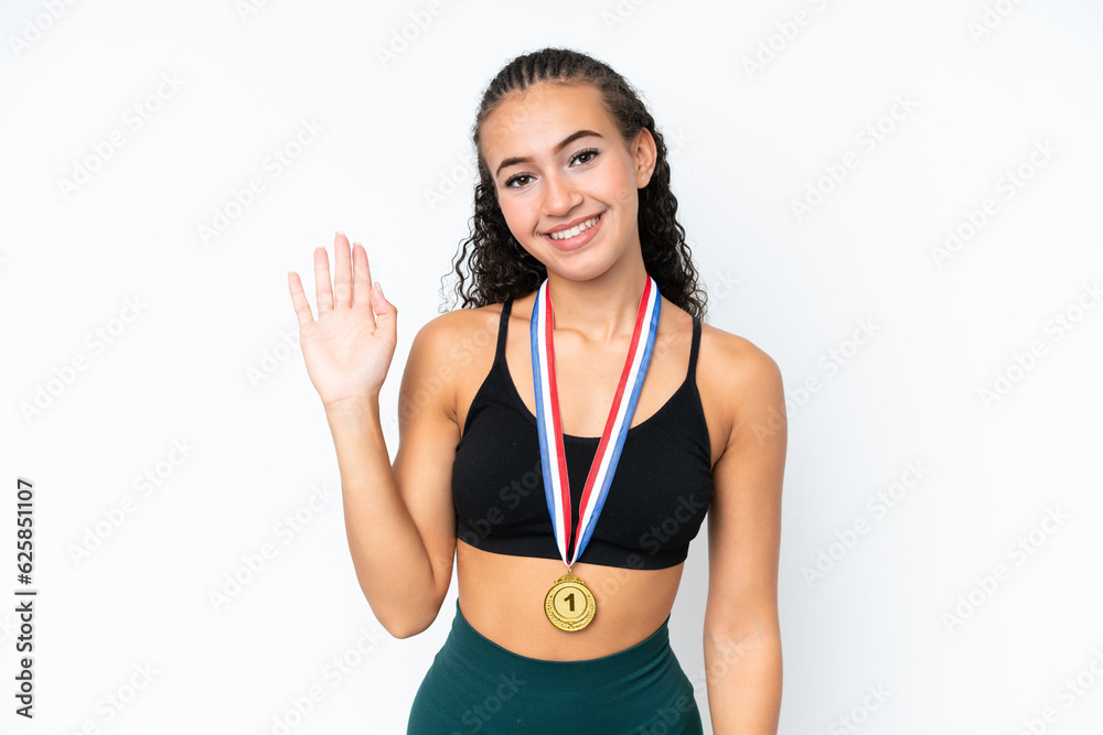 Young sport woman with medals isolated on white background saluting with hand with happy expression Young sport woman with medals isolated on white background saluting with hand with happy expression