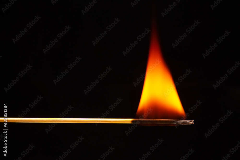Burning wood match on a dark background close-up. burning tree fire Burning wood match on a dark background close-up. burning tree fire