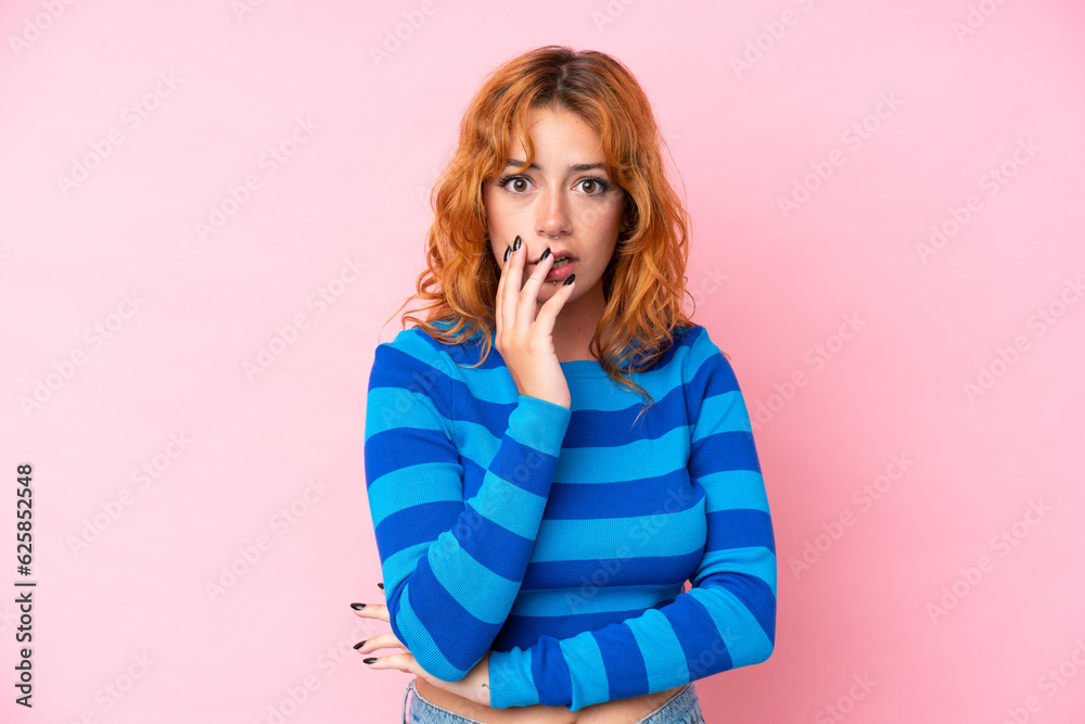 Young caucasian woman isolated on pink background surprised and shocked while looking right Young caucasian woman isolated on pink background surprised and shocked while looking right