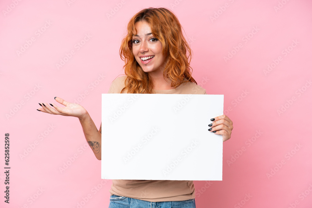 Young caucasian woman isolated on pink background holding an empty placard with surprised expression Young caucasian woman isolated on pink background holding an empty placard with surprised expression
