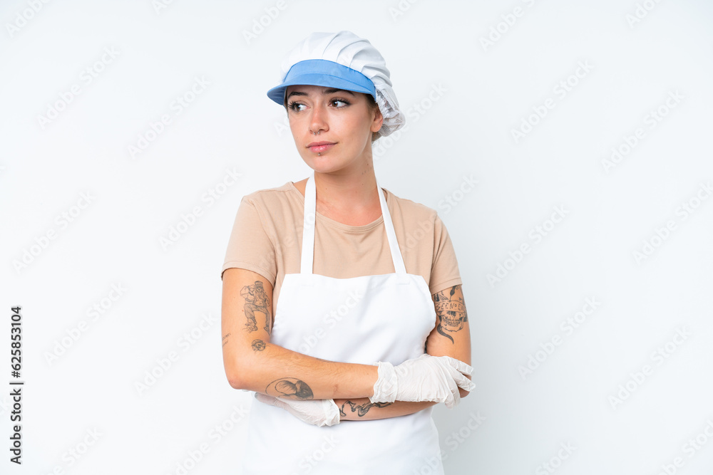 Fishmonger wearing an apron and holding a raw fish isolated on white background looking to the side Fishmonger wearing an apron and holding a raw fish isolated on white background looking to the side