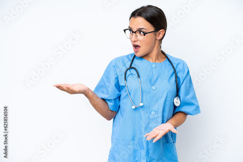 Fotografie Young nurse woman isolated on white background with surprise facial expression