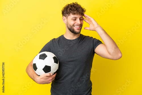 Handsome young football player man isolated on yellow background smiling a lot