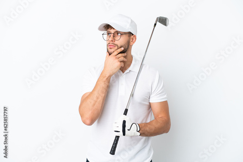 Handsome young man playing golf isolated on white background having doubts